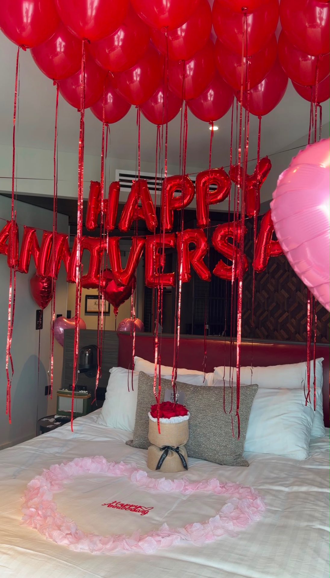 Happy Anniversary setup with red balloons and signature rose box
