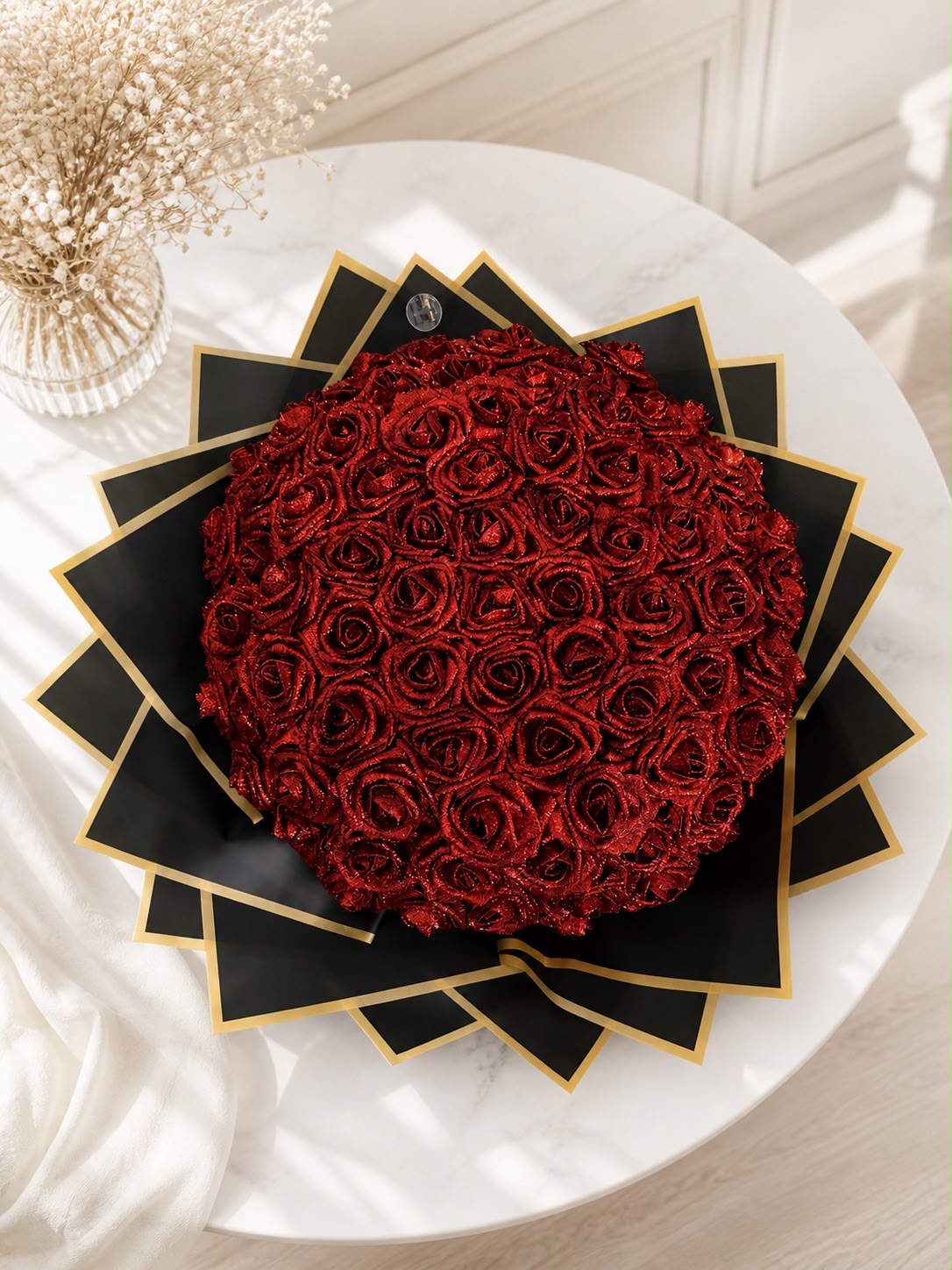 Red glitter rose bouquet with gold trimmed black wrapping