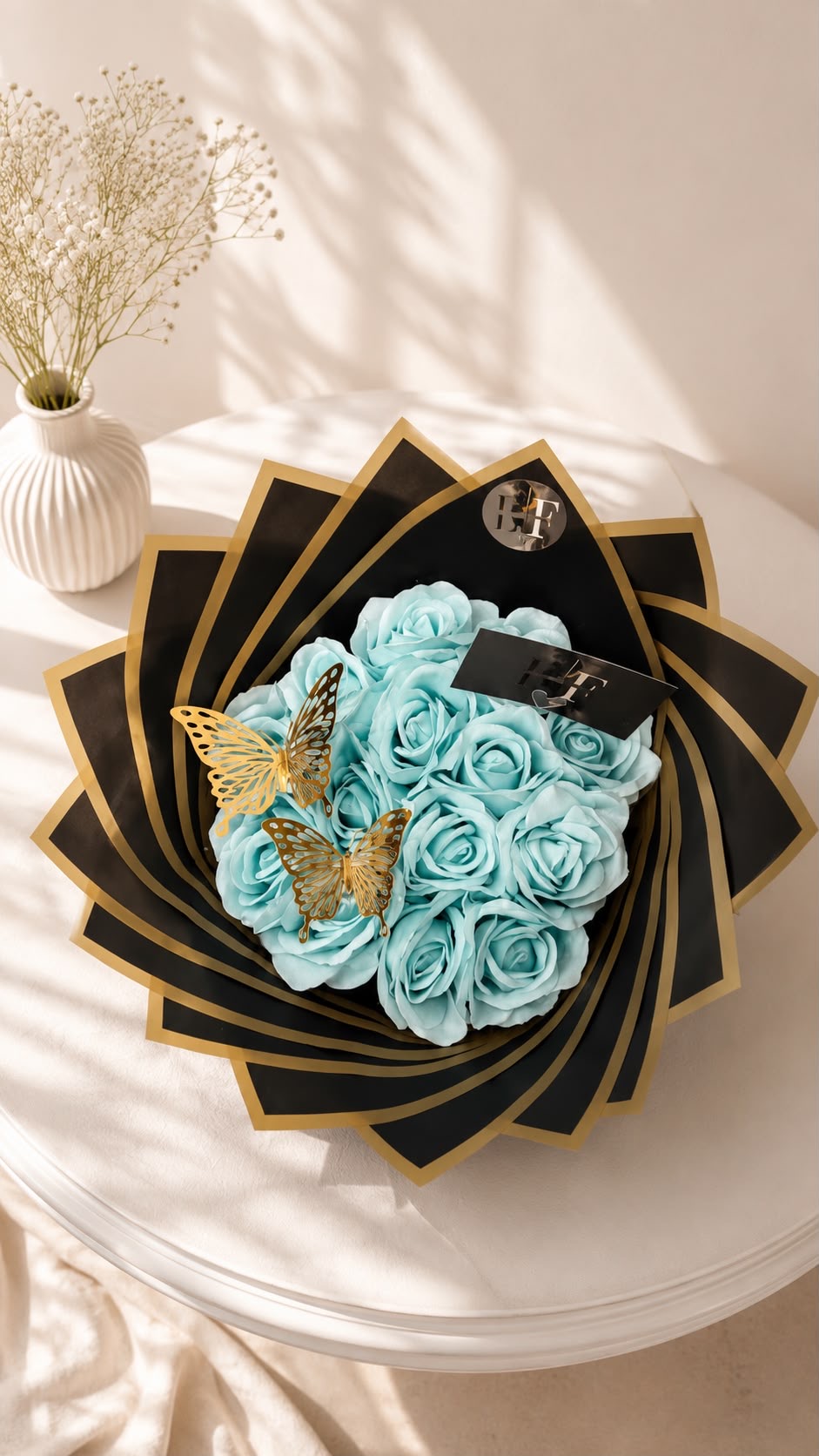 Tiffany blue rose bouquet with gold butterflies in black and gold fan wrap