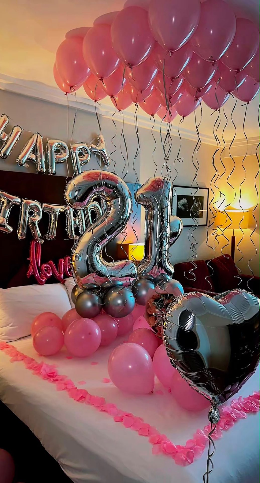 Happy 21st Birthday suite with pink balloon ceiling and silver number balloons