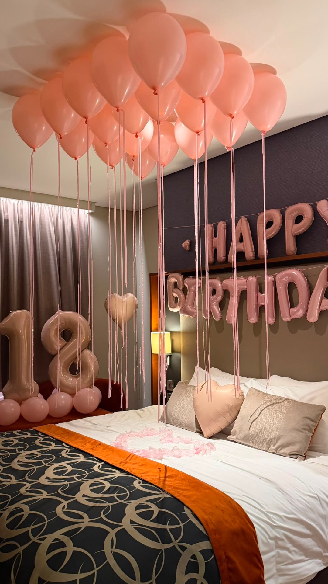 Happy 18th Birthday suite with blush pink balloon ceiling, rose gold number balloons and a heart of petals
