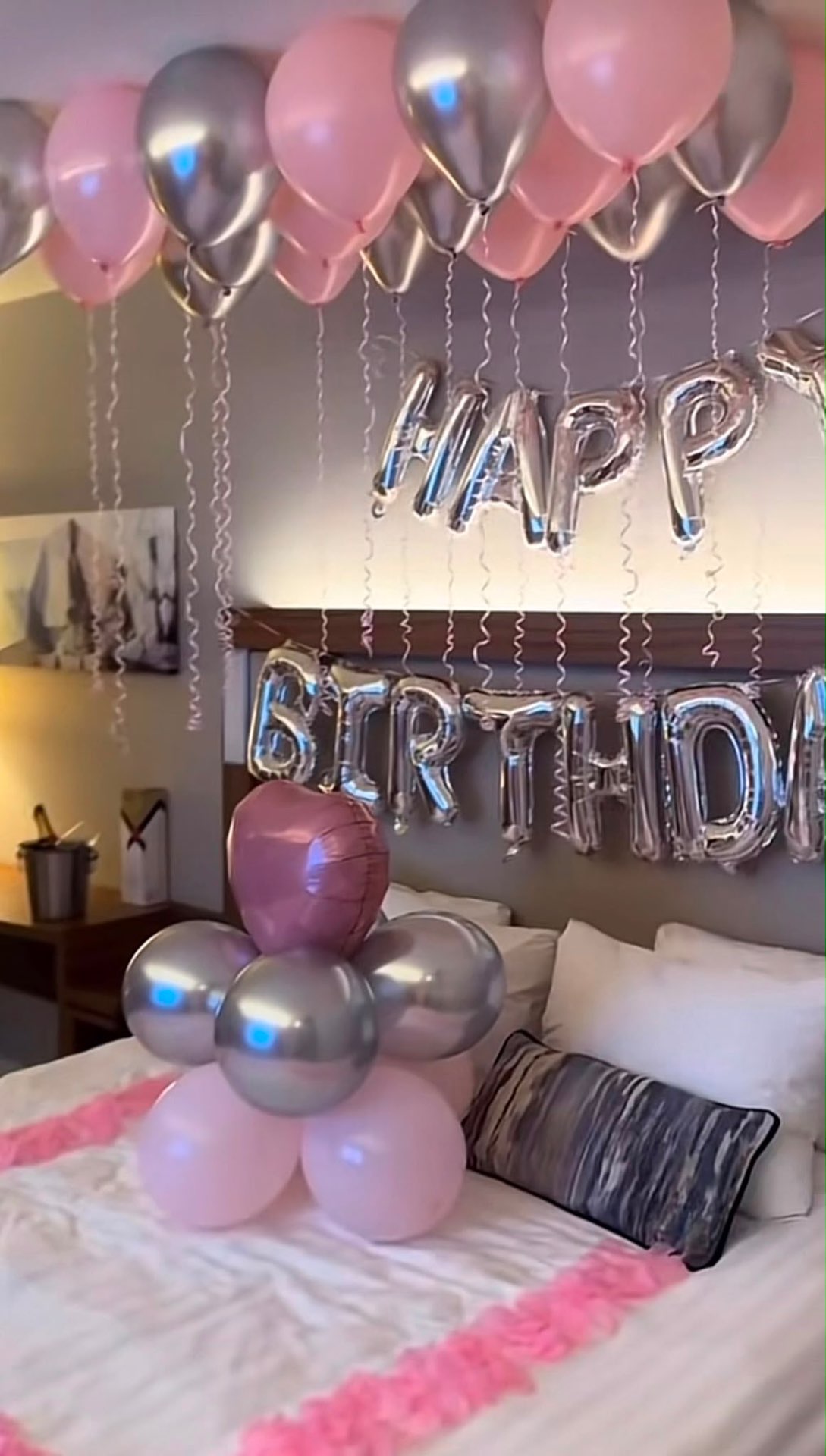 Birthday suite with blush and silver balloons and champagne on ice