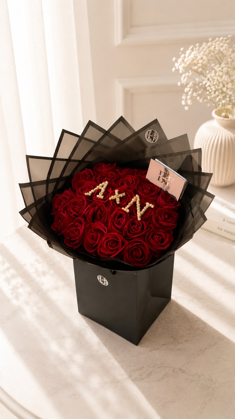 Red rose bouquet in a black self-standing EF box with pearl initials A & N