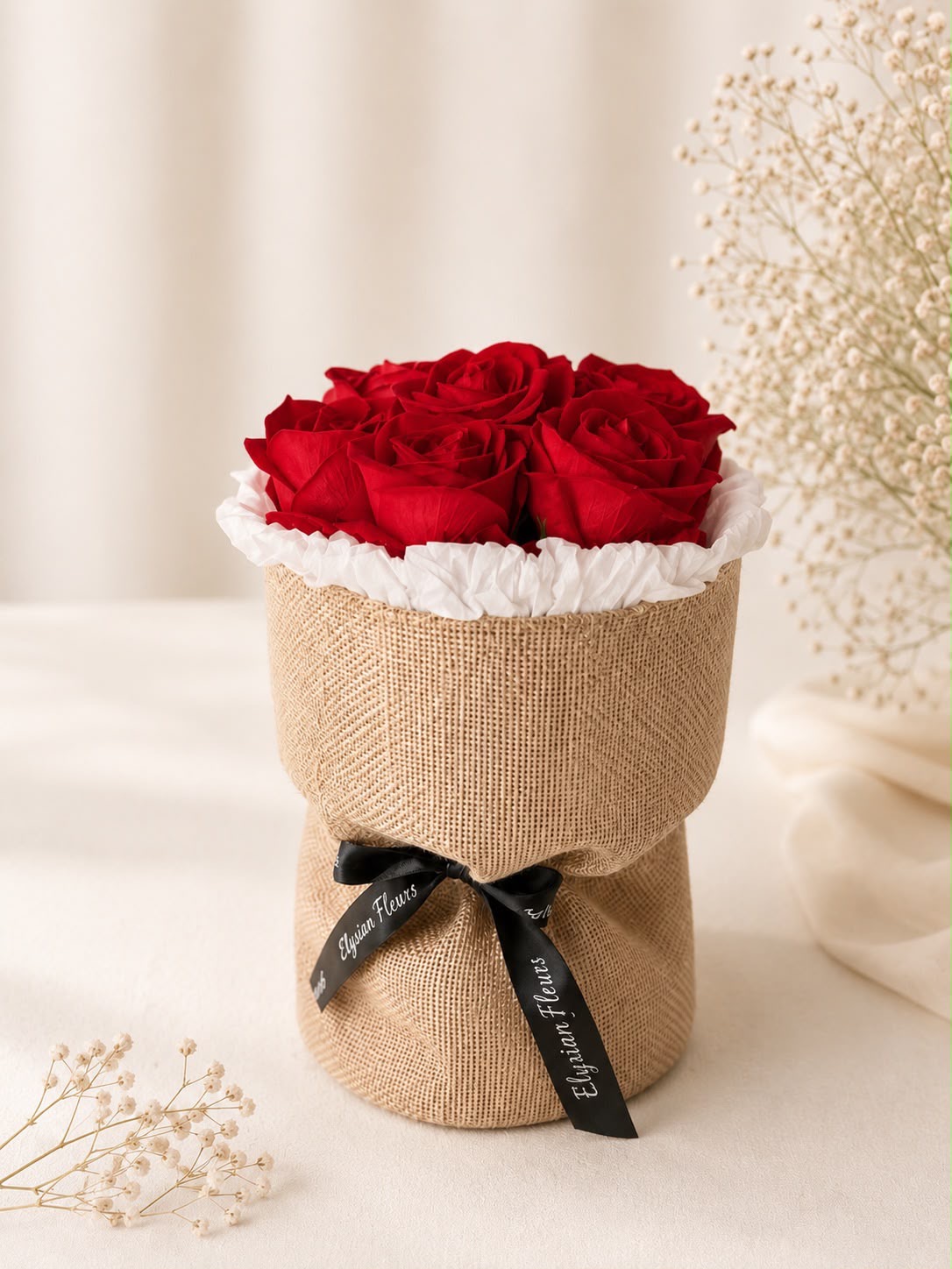 Petite red rose bouquet in signature burlap wrap with black EF ribbon