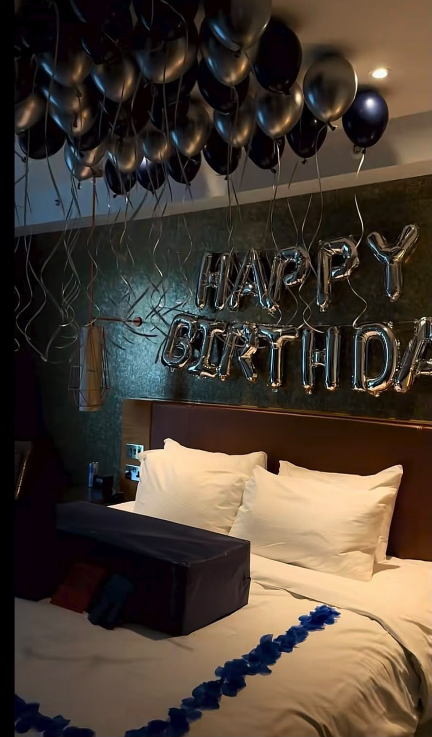 Intimate birthday suite with black balloons and silver Happy Birthday letters